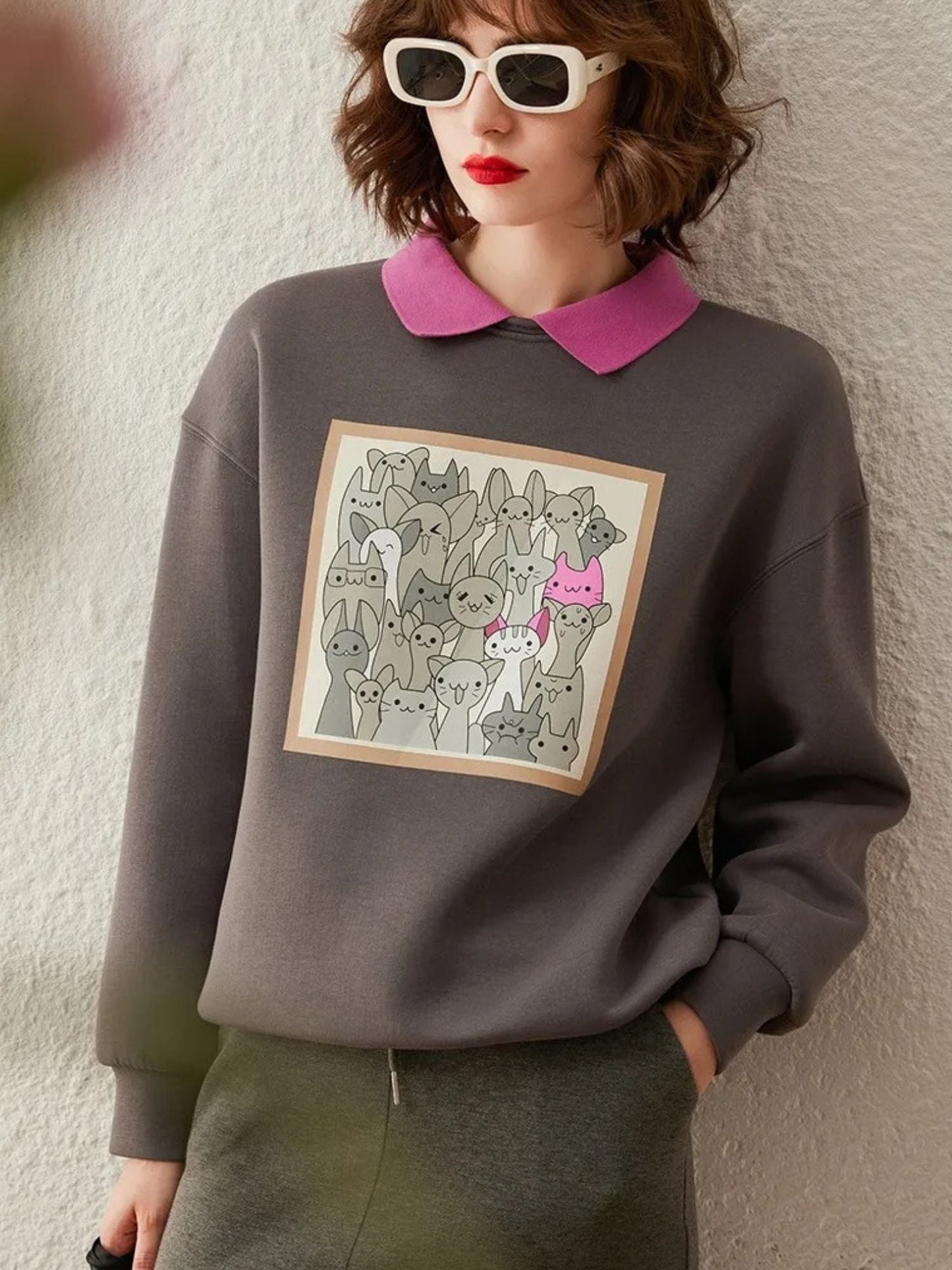 Angled view of grey sweatshirt tucked into a pencil skirt.