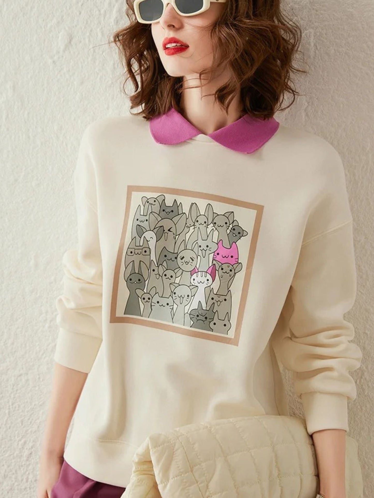 Front view of cream sweatshirt with forest-style print and pleated skirt.