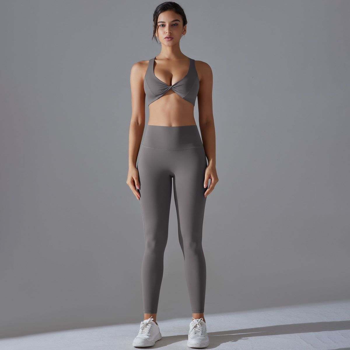 Women's sports bra with elegant twist design and high-waisted leggings Ivyshape