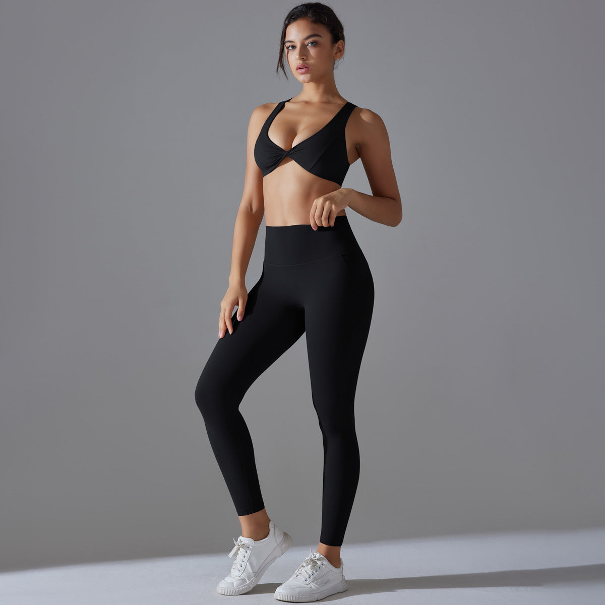 Women's sports bra with elegant twist design and high-waisted leggings Ivyshape