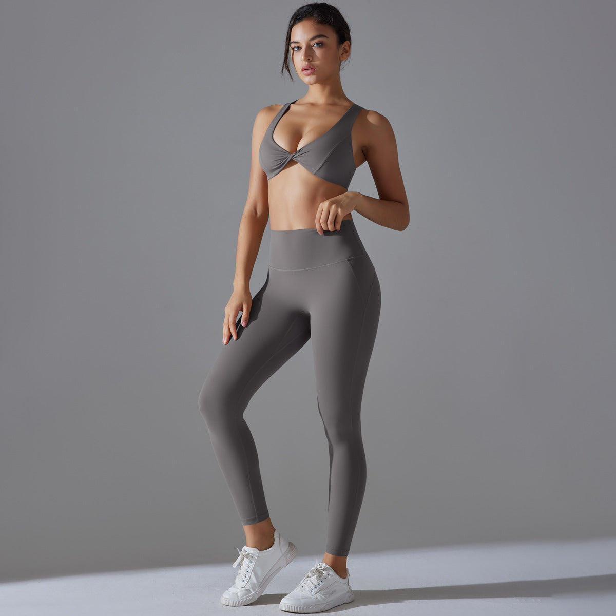 Women's sports bra with elegant twist design and high-waisted leggings Ivyshape