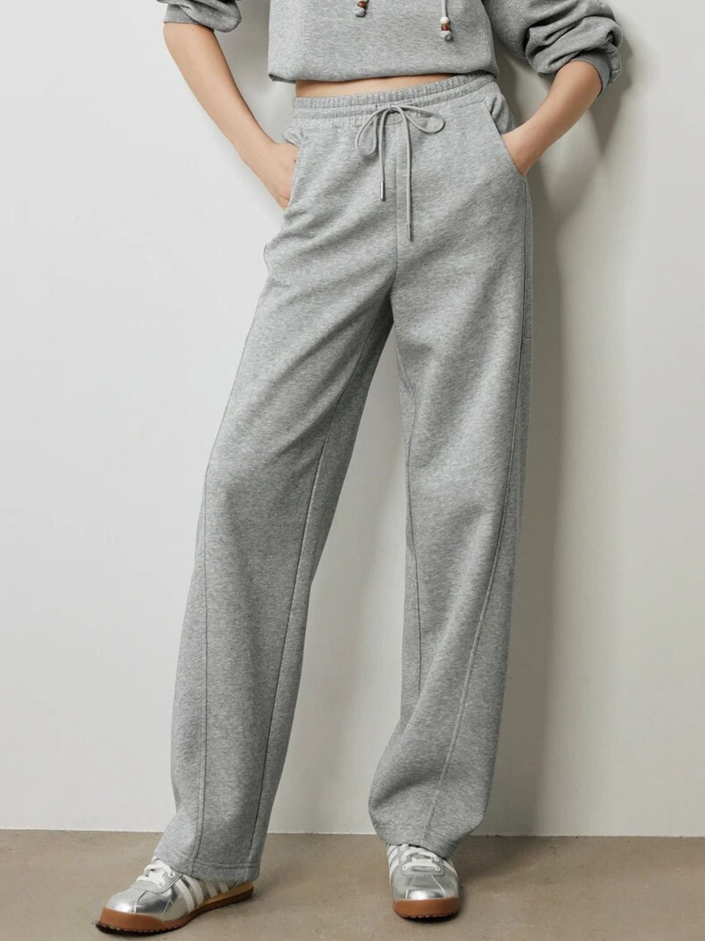 Model in light grey sweatpants with elastic waistband and cropped sweatshirt.